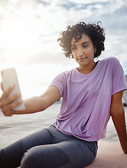 Image showing Fitness, exercise and woman taking a selfie on a phone while doing outdoor workout in the city. Healthy, young and girl athlete from puerto rico taking picture on smartphone while doing yoga on a mat