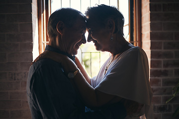 Image showing Love, dance and elderly couple hug in living room window, romantic and bonding in their home together. Romance, retirement and sweet seniors sharing a romantic moment, dancing and embracing in house