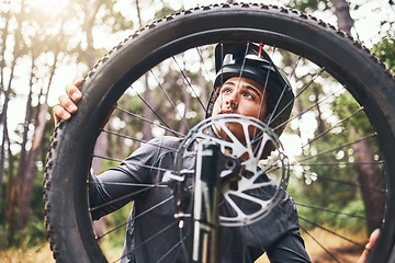 Image showing Bicycle, wheel and tyre in forest with man fix problem in zoom or closeup of rim. Cyclist, bike and broken in woods while on training, fitness and travel ride for sport or prepare for competition