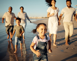 Image showing Family, girl and beach with children, parents and grandparents walking together on holiday by the sea. Happy generations of black family walk by the ocean in the sunset at reunion, vacation or travel
