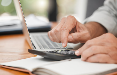 Image showing Calculator, laptop and hands of man calculating, accounting and home budget while doing online payments and sitting at a table at home. Closeup of a mature male accountant doing finance planning