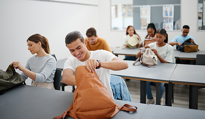 Image showing University students in a classroom, learning education at college in a diversity rich environment. Young men and women are excited to study and learn as they search for stationary in backpack.