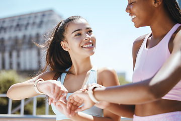 Image showing Watch, fitness motivation and friends running for cardio fitness in the city of Orlando together. African runner and women happy about sports training time on digital clock after workout in summer