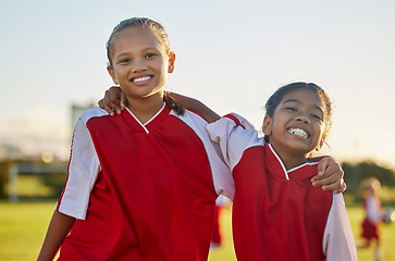 Image showing Girls, hug and soccer team in fitness game, kids workout and training on grass field, nature park or Thailand high school stadium. Portrait, smile or happy football children in energy sports exercise