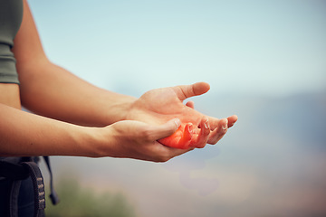 Image showing Hand injury, pain or accident of woman hiking outdoor on mountain for fitness and exercise. Closeup of injured or swollen muscle of girl athlete trekking in nature in need of emergency medical help.