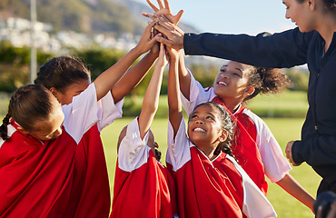 Image showing High five, team and girls soccer celebrate a victory and win on field with coach. Sports. young and female children smile, relax and happy they won soccer match with training, teamwork and together.