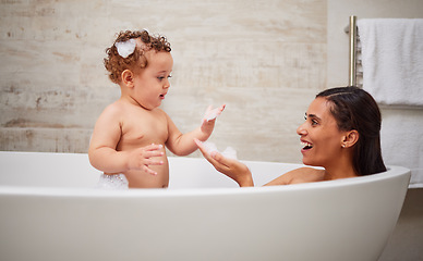 Image showing Mother, baby and bath in bathroom home, health and cleaning. Mom, parent and child or kid bathing in bubble bathtub, relax and having fun time with mama, bonding or care with healthy hygiene skincare