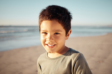 Image showing Portrait, smile and happy boy on beach for summer holiday on nature background with ocean, sea or sand. Children, kids or face of youth in California travel location with earth landscape and blue sky