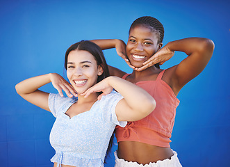 Image showing Cute friends happy in studio, women model fashion together on blue background and enjoy summer with portrait. Friendship diversity with funny smile pose, cool black woman and latino girl in Miami