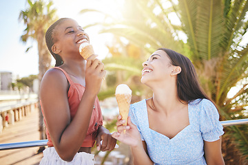 Image showing Ice cream, summer and women friends eating on Miami beach for holiday travel, vacation and outdoor youth lifestyle with sunshine lens flare. Happy, diversity teenager couple with icecream dessert