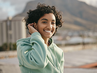 Image showing Face, smile and happy young woman feeling free and happy while smiling outside against an urban city background. Portrait of a indian female with an attractive, trendy or edgy style while on rooftop