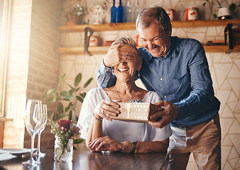 Image showing Gift, surprise and senior couple in restaurant for retirement celebration or happy birthday with wine glass, present and roses. Elderly woman with marriage anniversary event with vintage fine dining