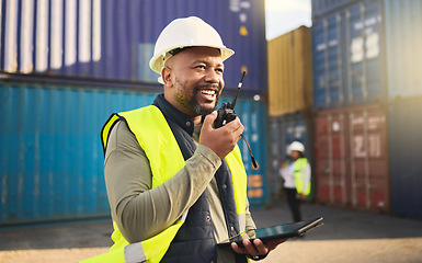 Image showing Logistics, radio and a black man in shipping container yard with tablet. Industrial cargo area, happy transport worker talking on walkie talkie in safety gear and working for global freight industry.