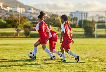 Image showing Football, competition and soccer athlete or teen group play game, training and practice on grass. Girl with a ball running, fitness and exercise on a sports club field with a team of young people