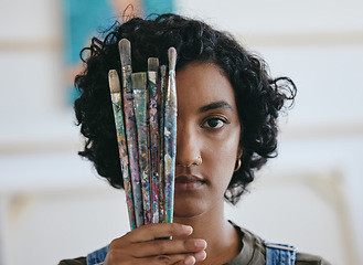 Image showing Brush, portrait and woman is a creative painter in an art gallery or workshop studio for watercolor painting. Freedom, artist and Indian girl with paintbrushes for her craft, hobby and drawing talent