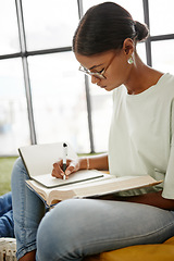 Image showing University student woman writing notebook, reading research and learning for education, knowledge and project at campus in Colombia. College youth study textbook, exam notes and school library books