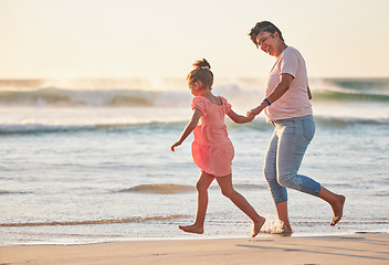 Image showing Family, child and grandma running on beach vacation having fun, energy and adventure with mature and girl holding hands on tropical summer trip. Active grandparent and happy kid traveling by the sea