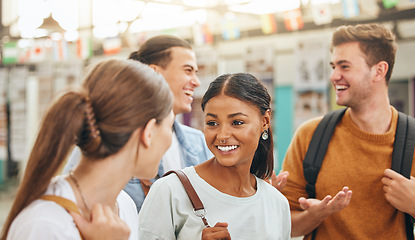 Image showing Learning, library and friends talking and bonding, having fun while meeting up for a group assignment. Diversity, education and students gathering at university to help with homework and project