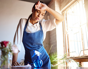 Image showing Cleaning house, burnout and tired cleaner working hard on dirty table and furniture feeling exhausted. Unhappy, frustrated and sweaty woman overworked in a difficult stressful job with daily pressure