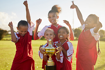 Image showing Children, football trophy and winning team of sports competition on soccer field for celebration of goal, win and teamwork after a match outdoors. Youth, kids or girls club after a tournament game