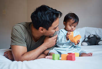 Image showing Father and down syndrome baby play education game with toys on bed for growth and happy together. Man smile in bedroom with toddler boy, learning color and development in home with building blocks