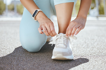 Image showing Tying shoes, running training and woman start workout, exercise and sports fitness in urban city outdoors. Closeup athlete feet, runner prepare sneakers and ready for cardio challenge performance