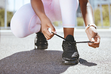 Image showing Tie shoes, marathon running and woman start training workout, exercise and sports fitness in outdoor urban city. Closeup athlete feet, runner foot sneakers and ready for cardio challenge performance