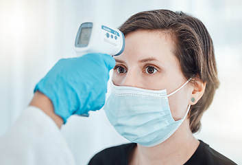 Image showing Covid, thermometer and doctor scan fever temperature of woman with mask consulting in hospital. Female patient test for healthcare, safety and protection against coronavirus, illness and virus.