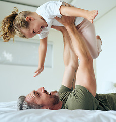 Image showing Family, dad and lifting daughter on bed while having fun and enjoying time together bonding during airplane game family activity. Playing, support and laughing man and girl child in bedroom at home