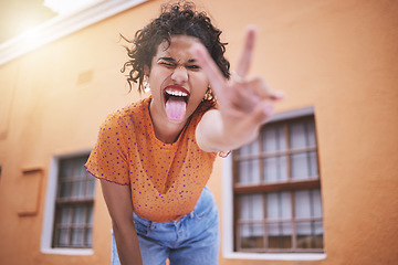 Image showing Closeup beautiful mixed race fashion woman pouting and gesturing peace against an orange wall background in the city. Young happy hispanic woman looking stylish and trendy. Carefree and fashionable