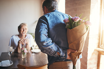 Image showing Surprise, flowers and senior couple in celebration of an anniversary, marriage or birthday at a restaurant. Elderly man giving bouquet of roses to woman during dinner date for love at a coffee shop