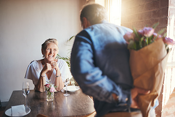 Image showing Elderly, couple and flowers on a date for surprise, love and romance in their house. Senior woman, man and retirement together with bouquet to celebrate marriage, birthday or anniversary in the home