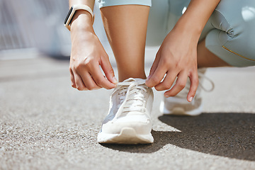 Image showing Shoes, feet and woman running in the street for fitness, cardio and marathon training in the city of Toronto. Shoelace of athlete runner ready for health workout, exercise and sports in the road