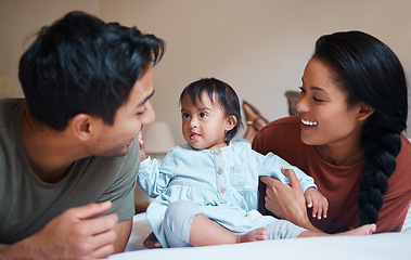 Image showing Down syndrome, mother and father bonding with child smile, happy and together at home for quality time. Family, man and woman with baby, kid and newborn with disability, special needs and cuddle.