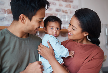 Image showing Love, happy parents and baby with down syndrome in the kitchen embracing and bonding in their home. Happiness, smile and family care with special needs or disabled child standing together in a house.