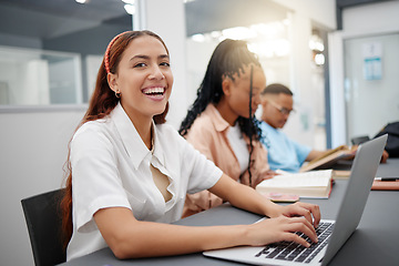 Image showing University, internet and student typing notes on laptop with smile at a table in a classroom of school. Portrait of a girl in college learning education in lecture and happy about campus wifi for pc