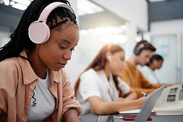 Image showing Education, headphones and black woman in university on laptop, typing notes and studying for test. Learning, college and female listening to music, educational podcast or radio working on project.