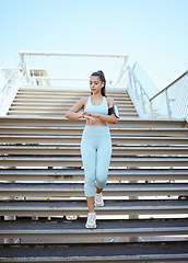 Image showing Fitness, smartwatch and health tracking with sports woman checking pulse and progress during exercise on building steps in a city. Training, time and cardio workout by Mexican girl monitor wellness