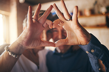 Image showing Love, hands and heart sign with senior couple relax and bonding in their home together, cheerful and in love. Support, soulmate and loving man and woman sharing romantic moment and enjoy relationship