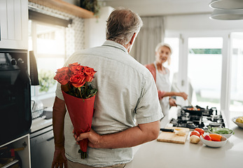 Image showing Surprise, roses and a senior couple at home with romantic man spoiling wife with a bouquet of flowers on an anniversary, birthday or valentines day at home. Husband hiding gift for a woman behind his