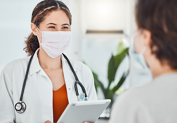 Image showing Covid, tablet and doctor consulting patient, woman or girl about test results, medicine or health. Healthcare worker, hospital employee or medical expert with safety mask talking to clinic client