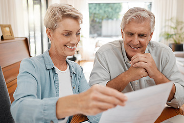 Image showing Happy couple, reading and paperwork or document for bill, mortgage or retirement plan or payout while sitting at home. Mature man and woman busy with tax compliance or finance form for pensioners