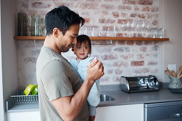 Image showing Baby, down syndrome and father holding and bonding with child in a kitchen, learning to care for special needs newborn. Love, awareness and disability care with girl enjoying time with loving parent