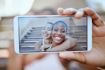 Image showing Phone, selfie and hand of friends smile for friendship photo together relaxing in the outdoors. Closeup portrait of young happy women smiling and holding mobile smartphone relax for picture