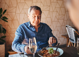 Image showing Senior man eating healthy and nutrition food at restaurant happy, satisfied and at table. Alone, elderly male and customer enjoy a delicious, meal with salad and fine dining for dinner, lunch or diet