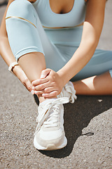 Image showing Sports, injury and fitness ankle pain during exercise, running and training outside with muscle or joint. Woman, risk and hurt hands athlete holding broken leg bone with bad bruise in the street