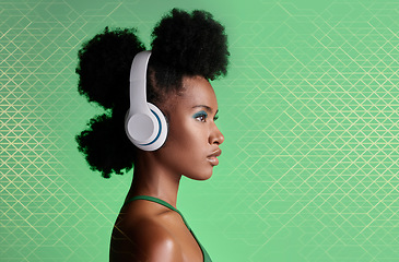 Image showing Black woman, music headphones and fashion hairstyle on studio background with green geometric patterns and makeup cosmetics. Style, trend or pride for beauty model listening to Jamaican radio podcast