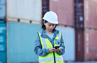 Image showing Warehouse, shipping and manager on a phone at factory plant, text and check delivery checklist and stock on online app. Cargo, logistics and supply chain management by asian woman control inventory