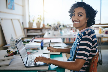 Image showing Creative black woman, smile and laptop working in art studio, workshop or design startup with notebook. Portrait of a happy African American female freelancer, designer or artist at work on computer