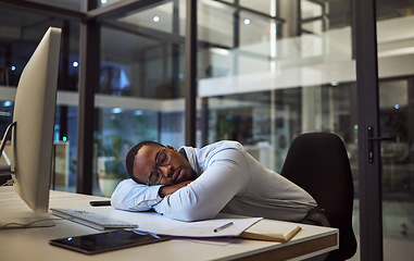 Image showing Night business, work sleep and businessman sleeping at desk with computer in dark office at a corporate company. Tired African manager or employee with burnout taking a nap while working overtime